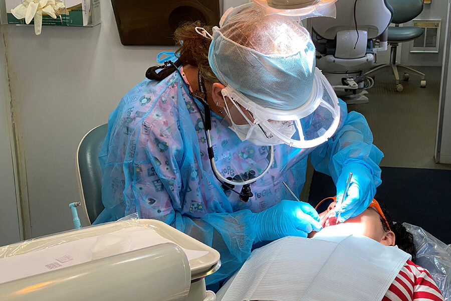 Dentist treats child on the mobile dental clinic