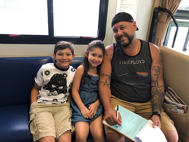 A father and his children visit the dental clinic